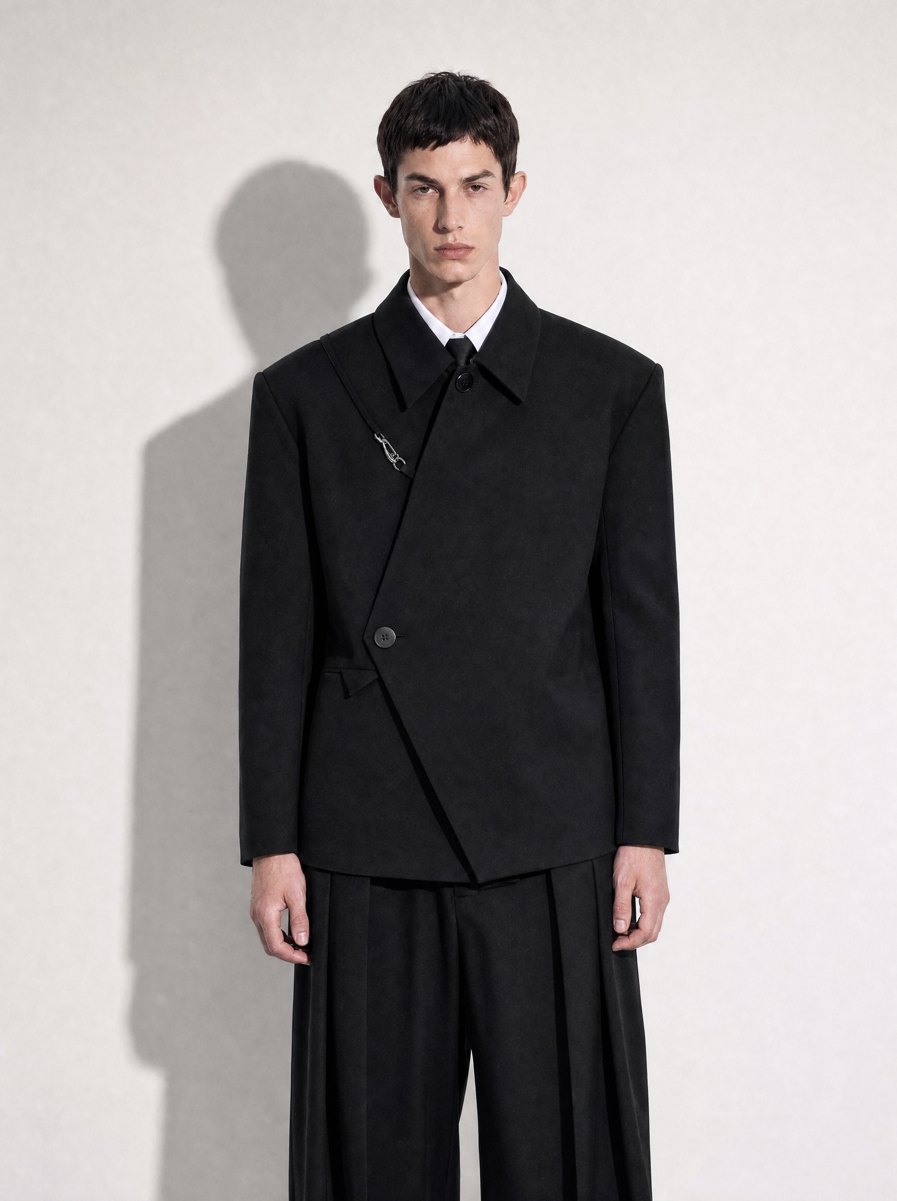 Asymmetric Wrap Blazer with Hook Clasp in black - half body front view showing wrap closure - nightcity clothing