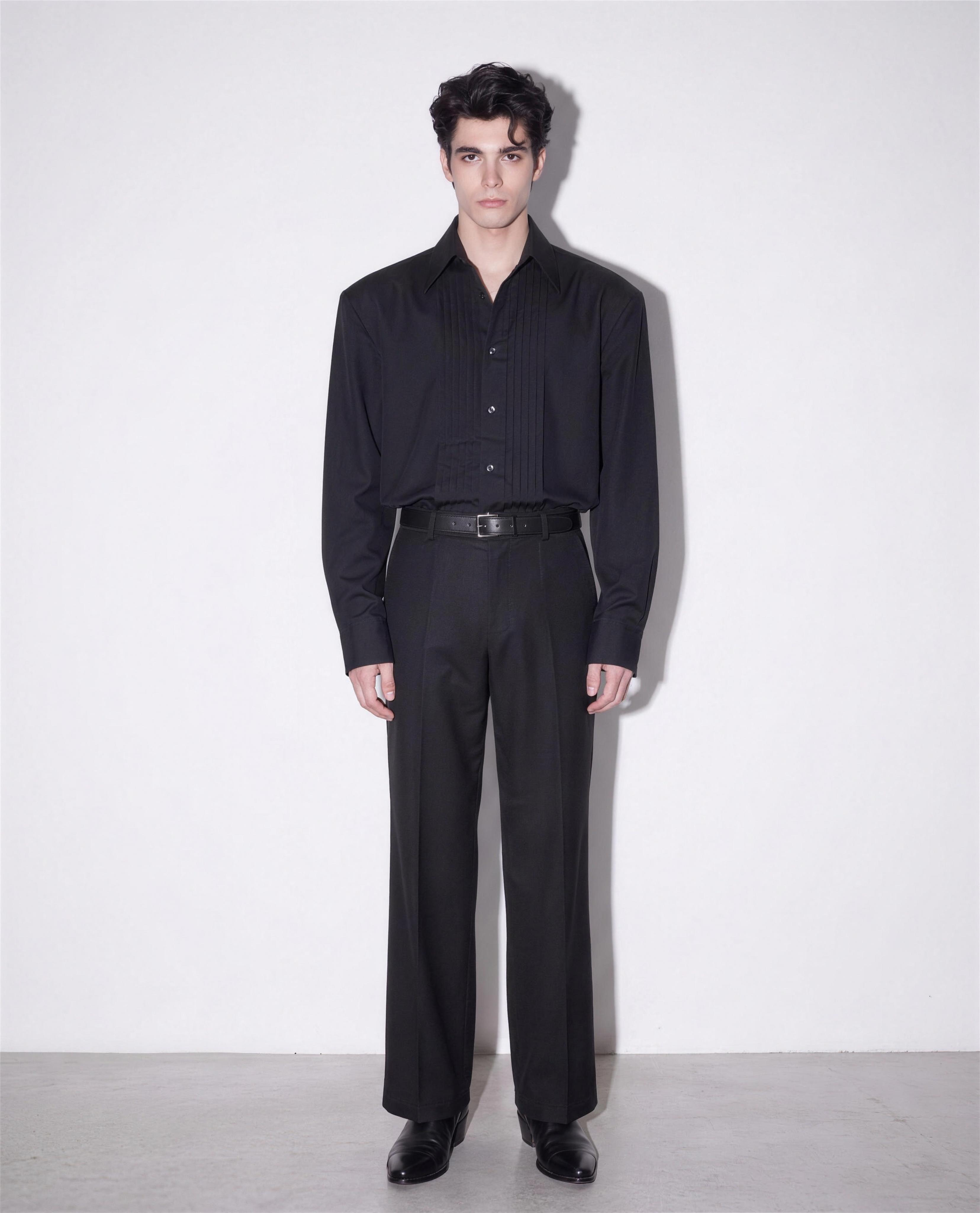 Boxy Pleated Front Pointed Collar Tuxedo Shirt in black, worn tucked with black wide-leg trousers - full body front view