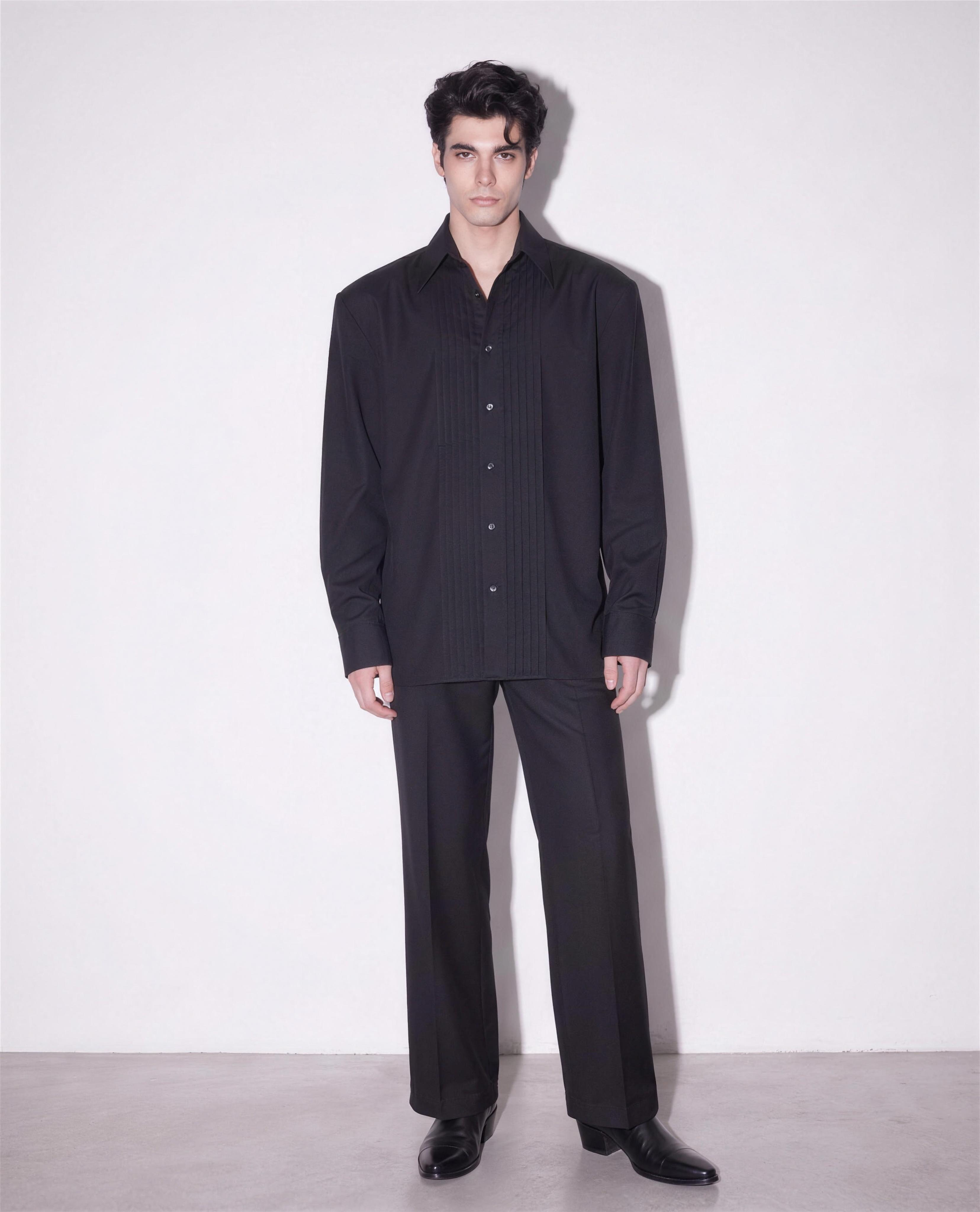 Boxy Pleated Front Pointed Collar Tuxedo Shirt in black worn untucked with black wide-leg trousers - full body view