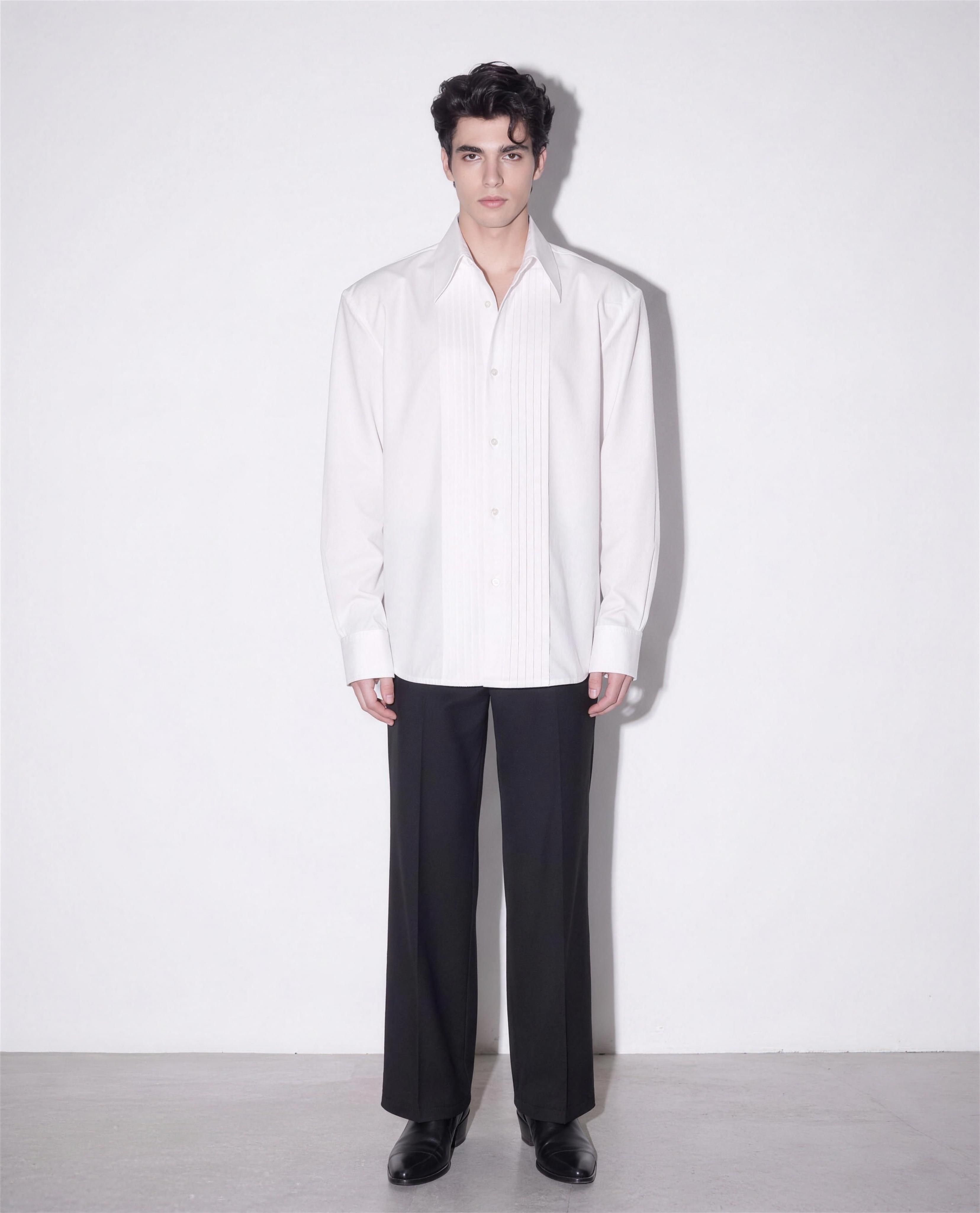Boxy Pleated Front Pointed Collar Tuxedo Shirt in white worn untucked with black wide-leg trousers - full body view