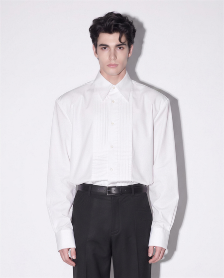 Boxy Pleated Front Pointed Collar Tuxedo Shirt in white - half body front view showing pleated bib and pointed collar